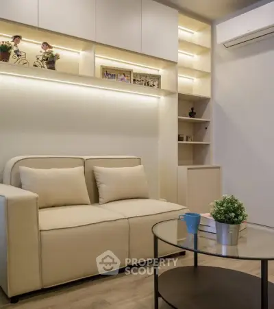 Modern living room with cozy beige sofa and stylish shelving, perfect for relaxation and entertainment.
