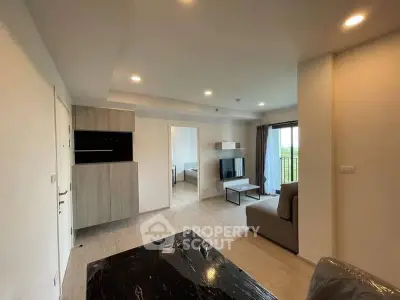 Modern living room with open layout and natural light in a stylish apartment.