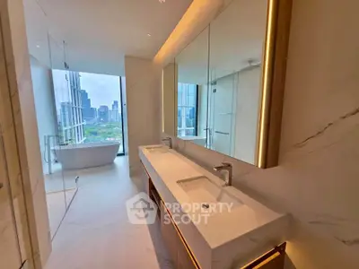 Luxurious bathroom with dual sinks and city view from glass-enclosed bathtub area.