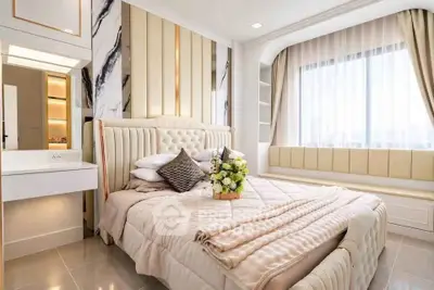 Luxurious bedroom with elegant decor and large window for natural light.