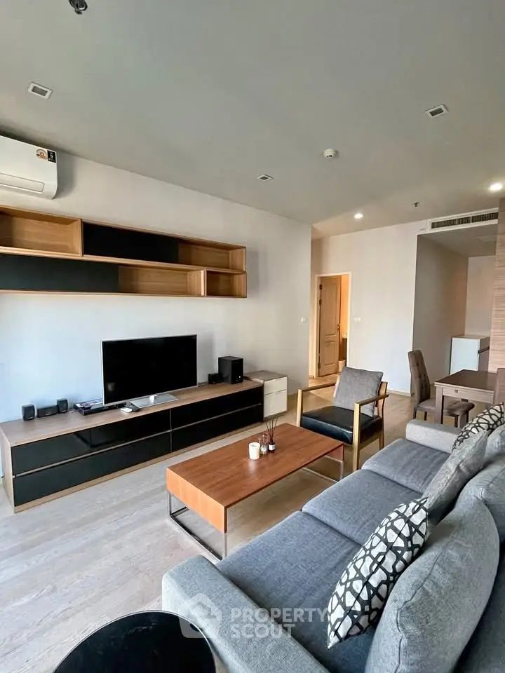 Modern living room with stylish furniture and entertainment center in a contemporary apartment.