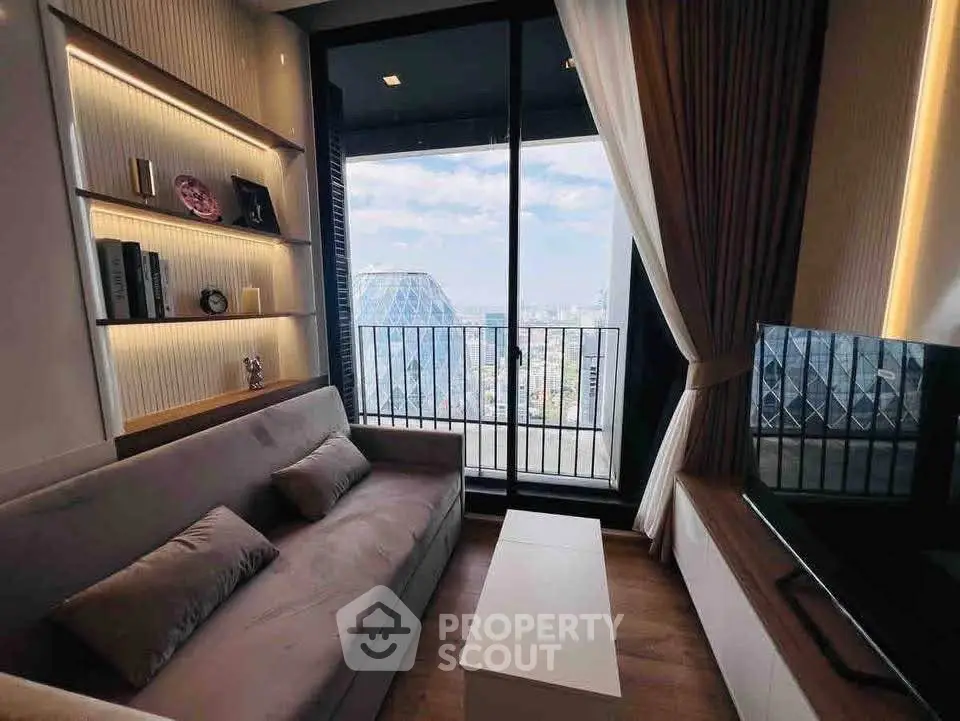 Modern living room with balcony and city view, featuring sleek furniture and stylish decor.