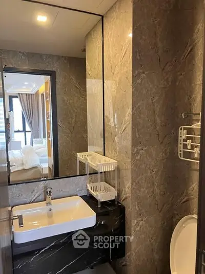 Modern bathroom with elegant marble walls and sleek fixtures