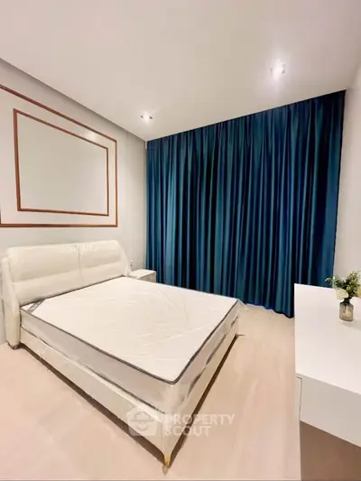Modern bedroom with elegant blue curtains and stylish decor