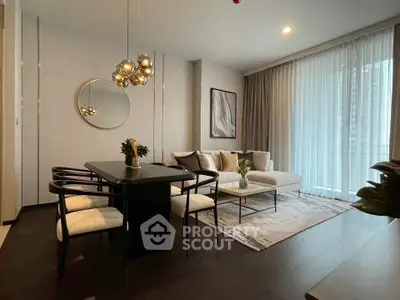 Elegant modern living room with stylish dining area and floor-to-ceiling windows.