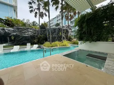 Luxurious poolside view with lush greenery and modern architecture in a high-end residential complex.