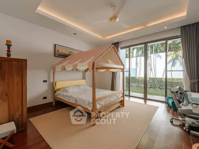 Charming bedroom with unique tent-style bed and garden view, perfect for a cozy retreat.