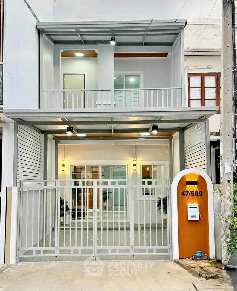 Modern townhouse exterior with sleek design and gated entrance, perfect for urban living.