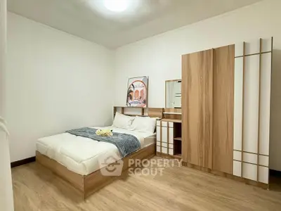 Modern bedroom with stylish wooden furniture and cozy bedding