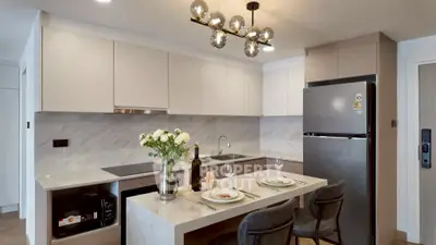 Modern kitchen with sleek design, featuring marble countertops and stylish lighting, perfect for culinary enthusiasts.