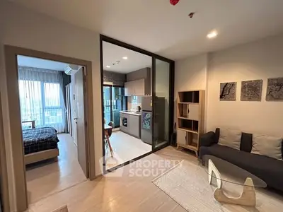 Modern open-plan apartment with cozy living room and stylish kitchen.