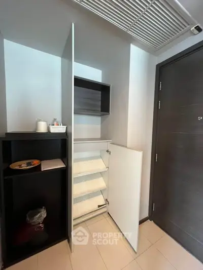 Modern entryway with sleek storage solutions and minimalist design.