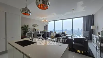 Luxurious open-plan living room with stunning city view, modern decor, and elegant lighting fixtures.