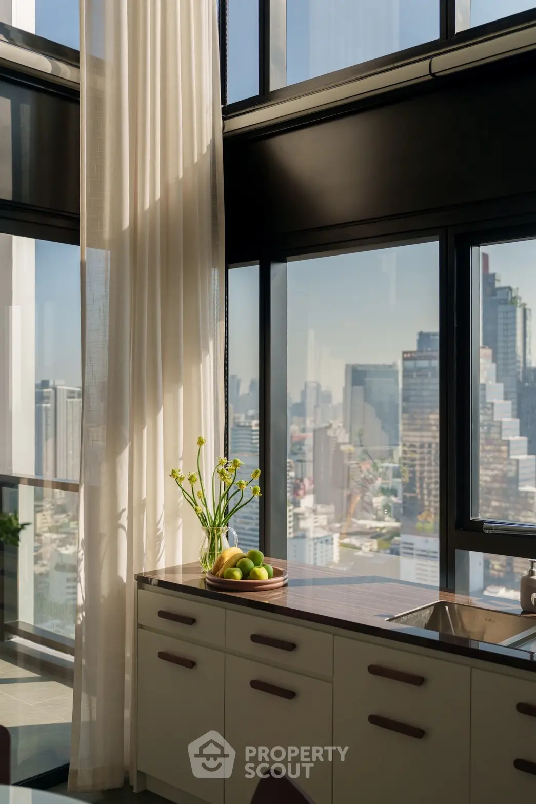 Luxurious high-rise kitchen with stunning city view and modern design