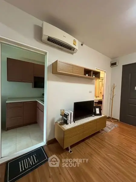 Modern living room with wooden flooring and open kitchen layout