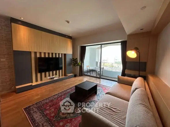 Spacious living room with modern decor and large balcony access