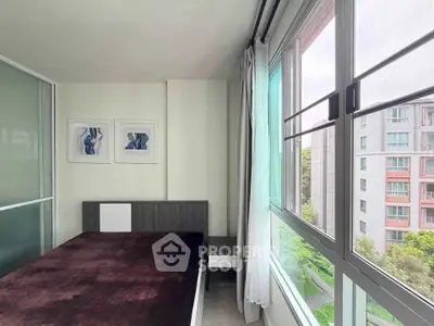 Modern bedroom with large windows offering a scenic view of the cityscape.