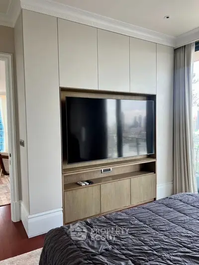 Luxurious bedroom with built-in TV and elegant decor