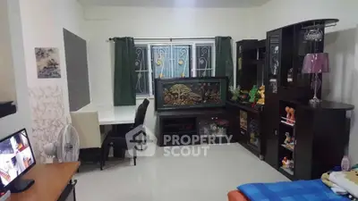 Spacious living room with elegant decor and large aquarium, perfect for relaxation.