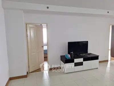 Spacious living room with modern TV stand and tiled flooring