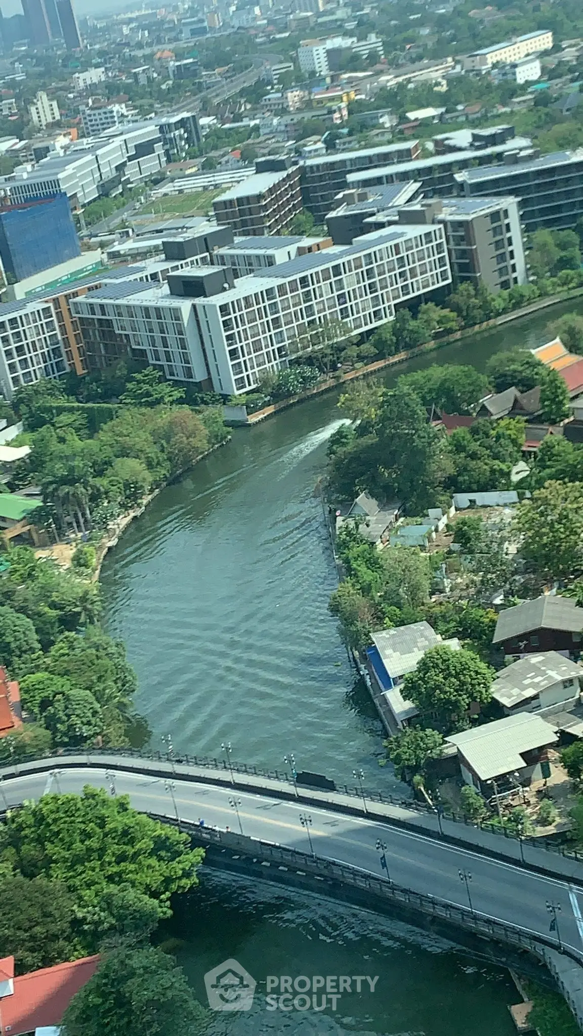Stunning aerial view of urban landscape with river and modern buildings, perfect for city living.