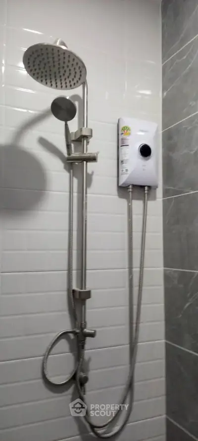 Modern bathroom shower with water heater and sleek tile design.