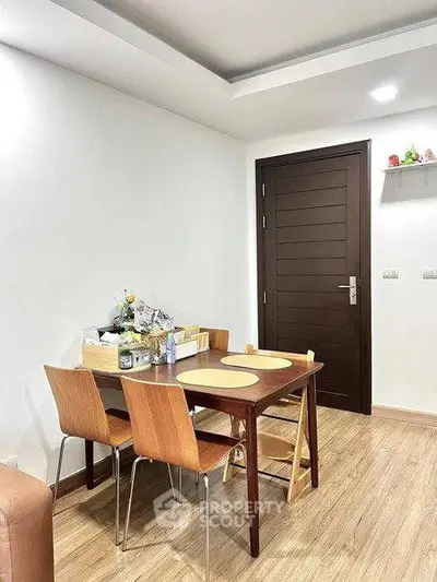Cozy dining area with wooden table and chairs in modern apartment