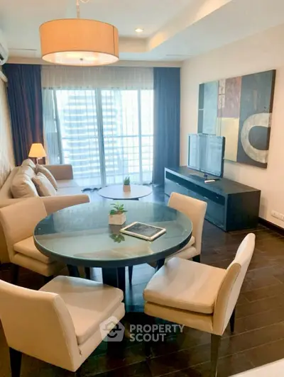 Stylish living room with modern furniture and large windows offering city views.