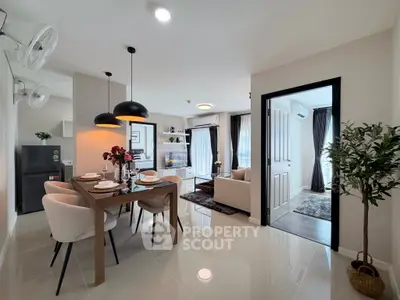 Modern open-plan living room and dining area with elegant decor and natural light.