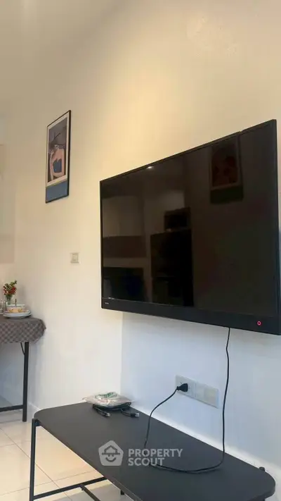Modern living room with wall-mounted TV and stylish decor