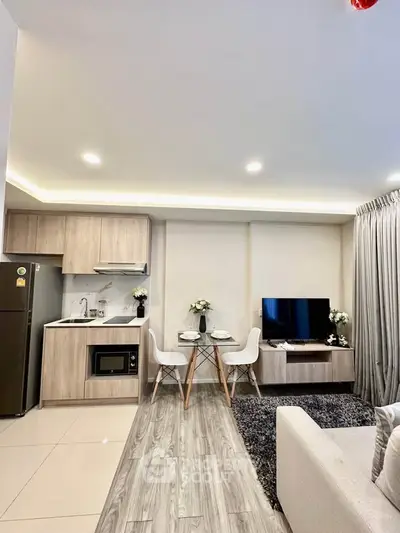 Modern open-plan living room with kitchen, dining area, and stylish decor