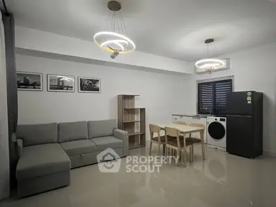 Modern living room with sleek furniture and stylish lighting in a contemporary apartment.