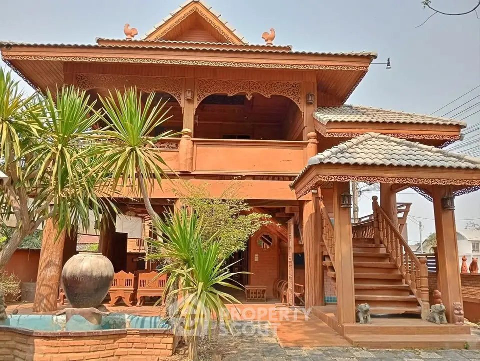 Stunning traditional wooden house with intricate carvings and lush garden