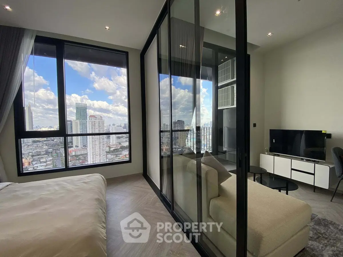 Modern condo with stunning city view, featuring a cozy living area and large windows for natural light.