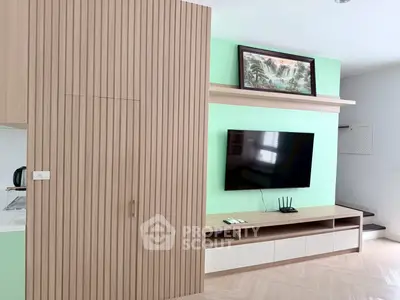 Modern living room with sleek wooden paneling and mounted TV, perfect for contemporary living.
