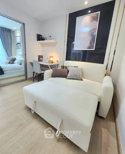 Modern living room with stylish decor and cozy seating in a contemporary apartment.