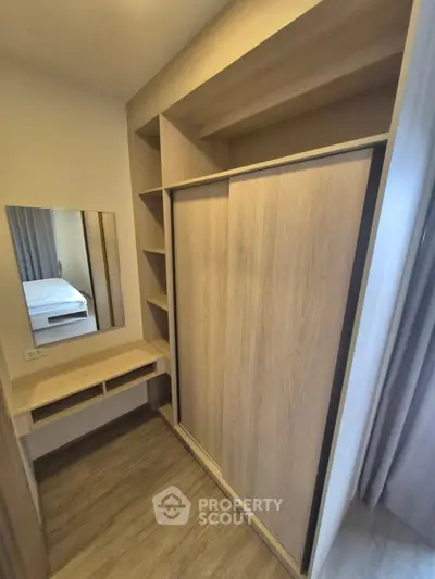 Modern bedroom with built-in wardrobe and vanity in stylish apartment