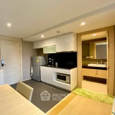 Modern kitchen with sleek appliances and open layout in stylish apartment