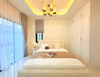Luxurious bedroom with elegant lighting and ample storage in modern apartment