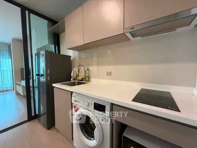 Modern kitchen with sleek appliances and open layout in stylish apartment