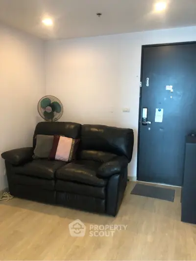 Cozy living room with black leather sofa and modern decor