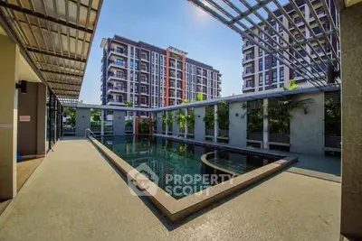 Modern apartment complex with stylish pool and lush greenery