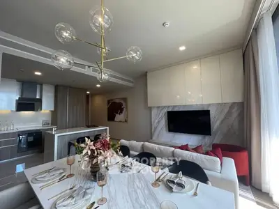 Luxurious open-plan living room with modern kitchen and elegant dining area.