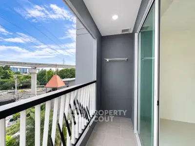 Modern balcony with sleek railing and city view, perfect for relaxation and enjoying the outdoors.