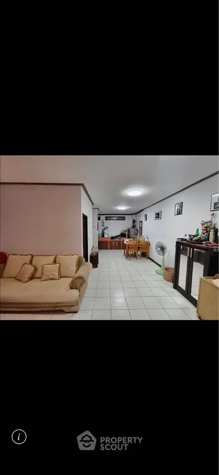 Spacious living room with cozy seating and dining area, perfect for family gatherings.