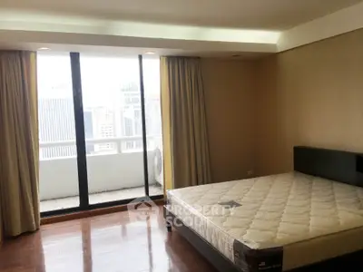 Spacious bedroom with city view and large windows in modern apartment