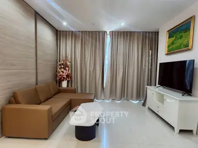 Modern living room with brown sofa, marble coffee table, and large TV for stylish comfort.