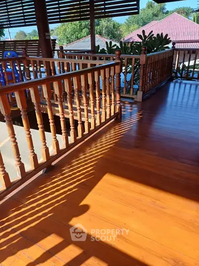 Spacious wooden balcony with scenic view and natural light