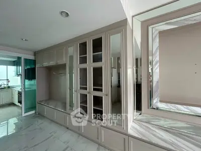 Spacious modern kitchen with sleek cabinetry and marble flooring
