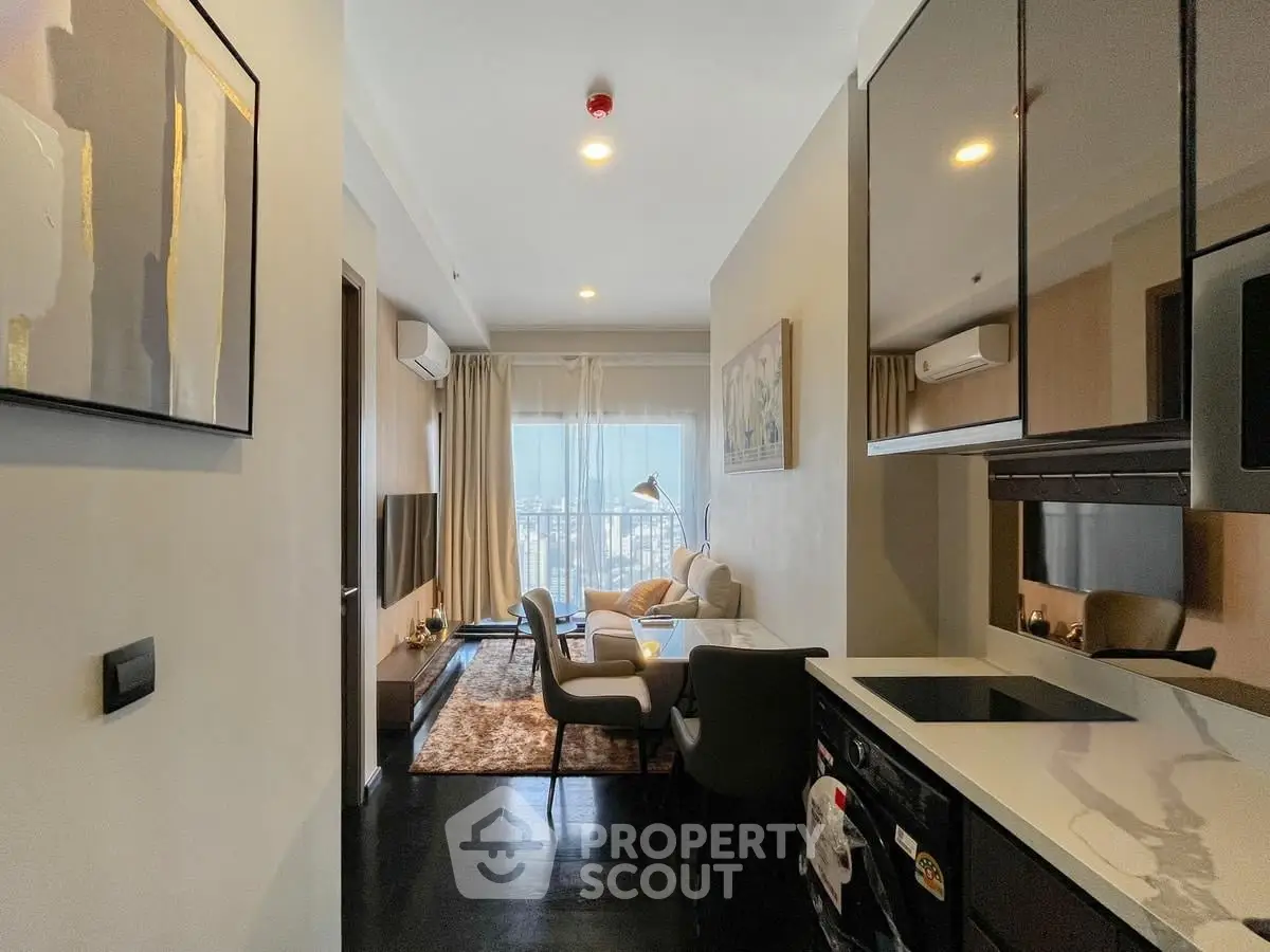 Modern open-layout living room with kitchen, featuring sleek design and city view.